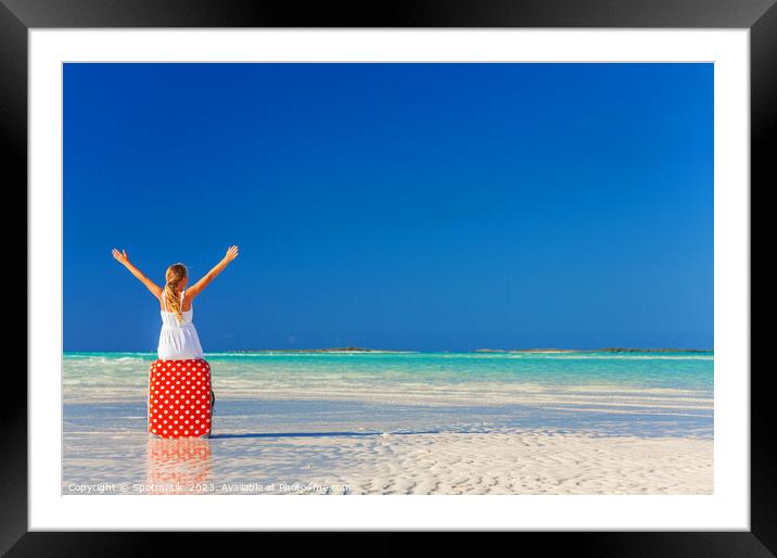 Blonde girl having beach fun sitting on suitcase Framed Mounted Print by Spotmatik 