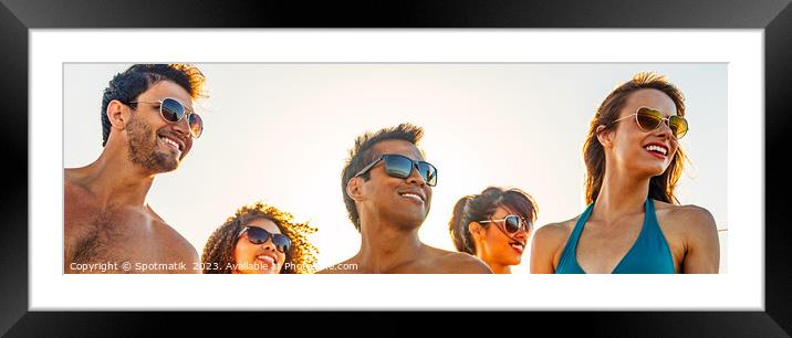 Panoramic view of smiling young friends in sunglasses Framed Mounted Print by Spotmatik 