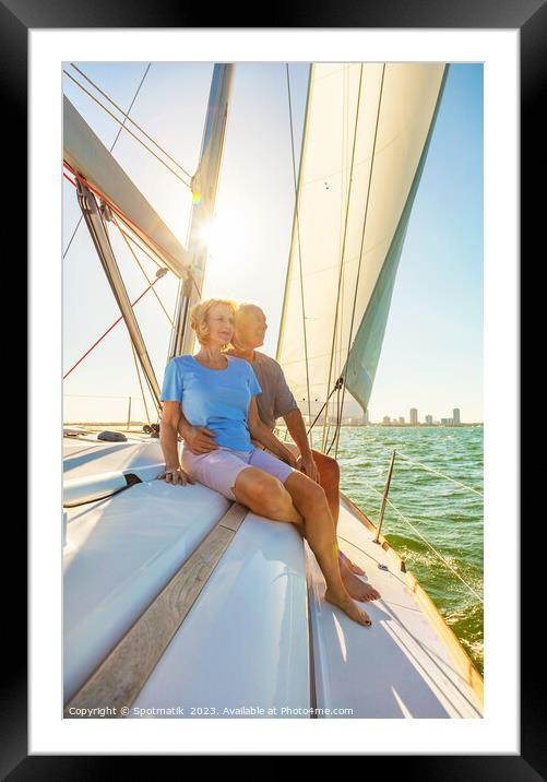 Senior couple enjoying togetherness on yacht at sunset Framed Mounted Print by Spotmatik 