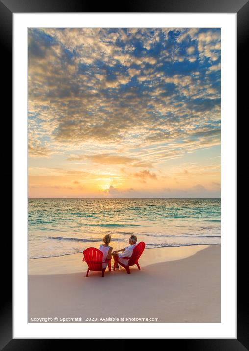 Retired Caucasian couple on beach at sunset Bahamas Framed Mounted Print by Spotmatik 