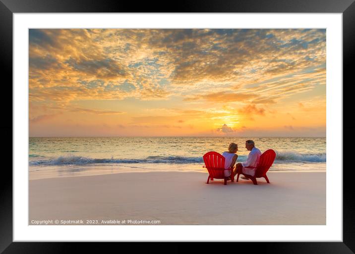 Mature couple enjoying ocean sunset on beach Bahamas Framed Mounted Print by Spotmatik 