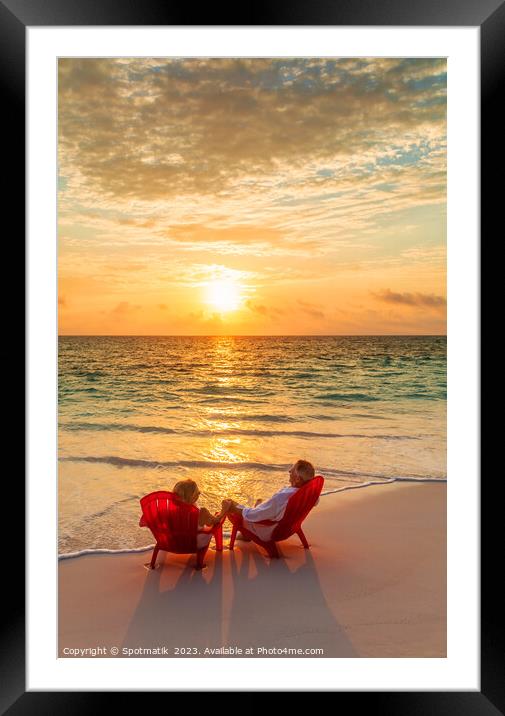 Sunset view with retired couple relaxing by ocean Framed Mounted Print by Spotmatik 