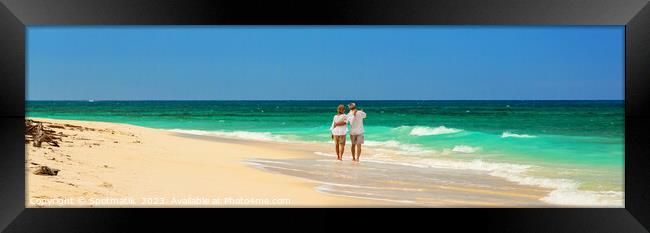 Panoramic view retired couple walking by turquoise ocean Framed Print by Spotmatik 