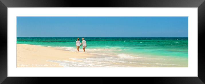 Panoramic retired couple by ocean at island resort Framed Mounted Print by Spotmatik 