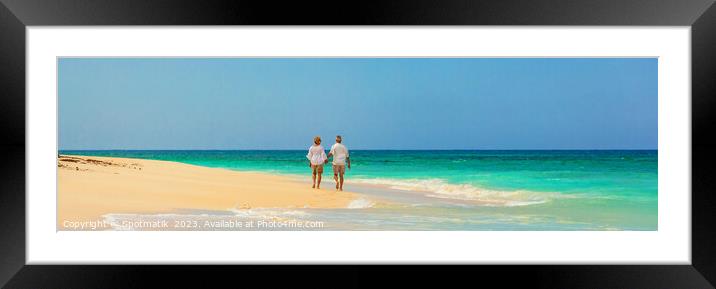 Panoramic view mature couple walking on beach Bahamas Framed Mounted Print by Spotmatik 