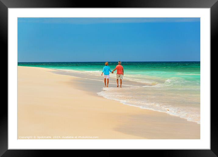 Mature couple paddling on tropical island shoreline Bahamas Framed Mounted Print by Spotmatik 