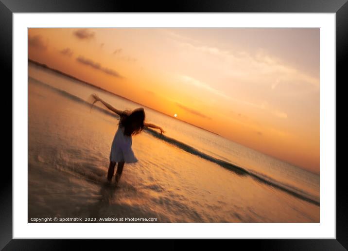 Motion blur girl standing in ocean at sunrise Framed Mounted Print by Spotmatik 