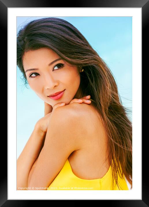 Portrait of smiling young Asian female relaxing outdoors Framed Mounted Print by Spotmatik 