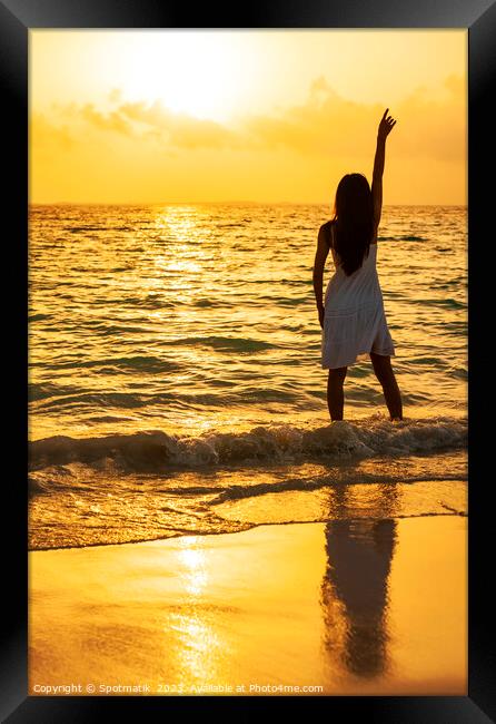 Young Asian woman enjoying ocean sunset on vacation Framed Print by Spotmatik 