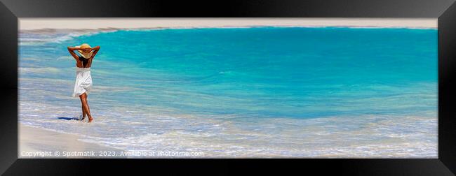 Panoramic ocean with young female walking in waves Framed Print by Spotmatik 