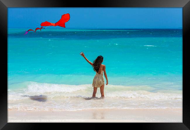 Asian girl standing in ocean waves flying kite Framed Print by Spotmatik 
