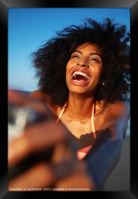 Laughing African American woman taking selfie on beach Framed Print by Spotmatik 