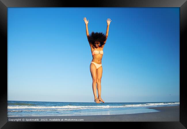 Afro American woman in swimwear jumping for joy Framed Print by Spotmatik 