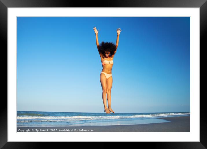 Afro American woman in swimwear jumping for joy Framed Mounted Print by Spotmatik 