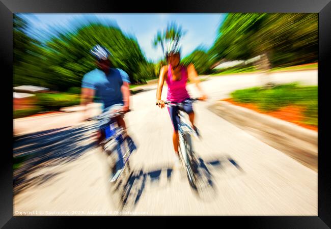Afro American cyclists riding bikes in motion blur Framed Print by Spotmatik 