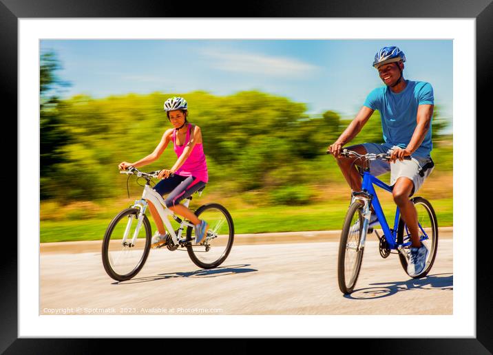 Leisurely cycle ride for young African American couple Framed Mounted Print by Spotmatik 