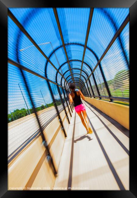 Young Afro American woman running through covered walkway Framed Print by Spotmatik 