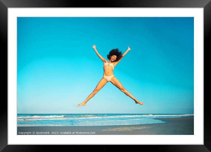 Healthy African American girl jumping high on beach Framed Mounted Print by Spotmatik 