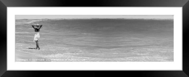 Happy young female walking through waves on beach Framed Mounted Print by Spotmatik 
