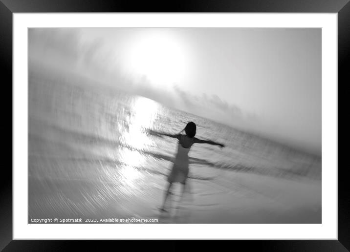Motion blur carefree Asian female dancing on shoreline Framed Mounted Print by Spotmatik 