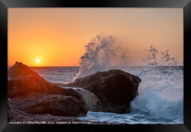 Sea waves crushing and splashing on the rocks in beautiful warm  Framed Print by Arthur Mustafa