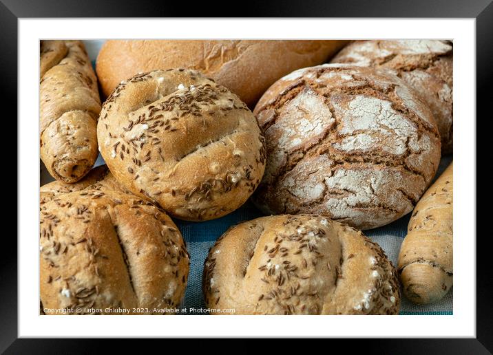 Heap of various bread rolls sprinkled with salt, caraway and sesame. Fresh rustic bread from leavened dough. Assortment of freshly of bakery products Framed Mounted Print by Lubos Chlubny