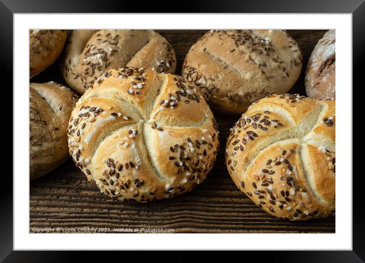 Different bread on a rustic wooden background. Bakery assortment of bread. Framed Mounted Print by Lubos Chlubny