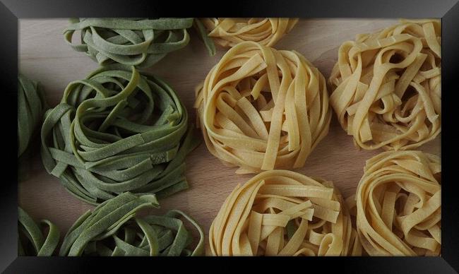 Fresh homemade egg pasta tagliatelle. Raw homemade pasta. Fettuccine pasta raw. Framed Print by Irena Chlubna