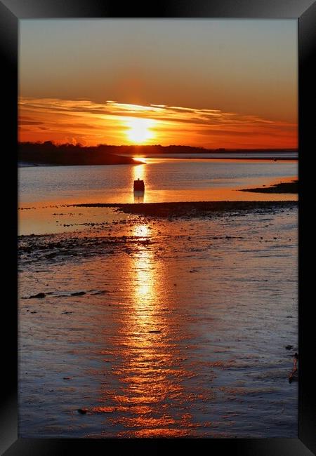 Sun setting across the Brightlingsea Creek.  Framed Print by Tony lopez