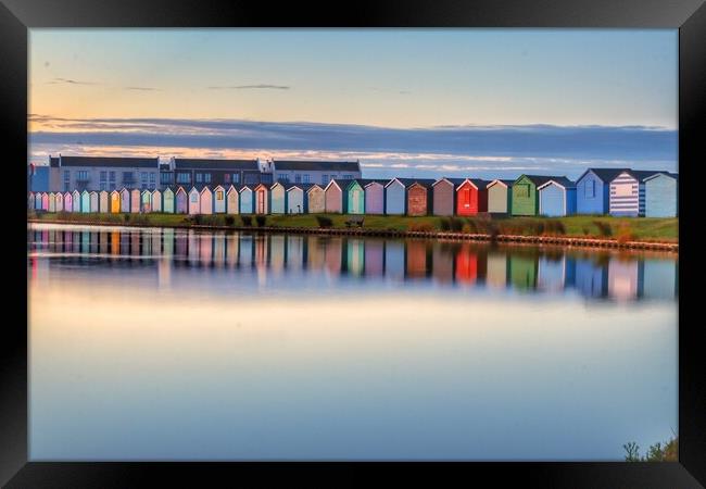 Sunrise reflections along the beach huts  Framed Print by Tony lopez