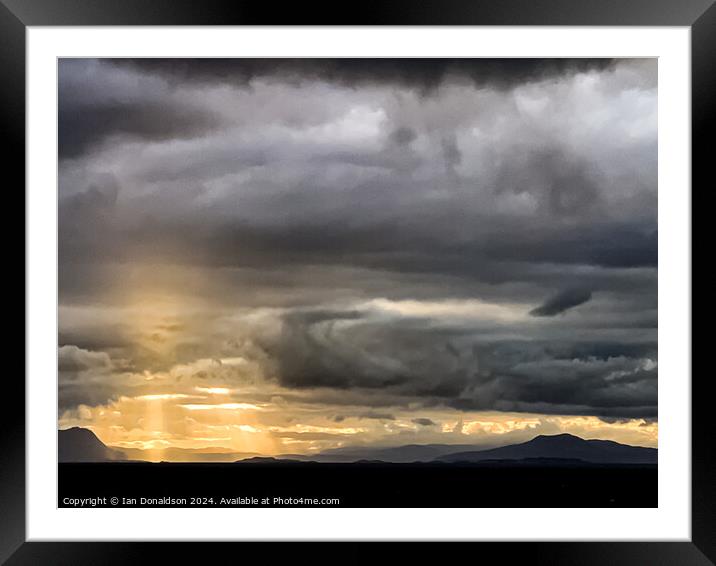 Sunlight Breaking Through a Stormy Scottish Sky Framed Mounted Print by Ian Donaldson
