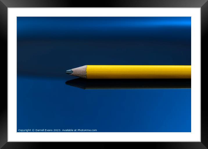 Yellow pencil on a blue background Framed Mounted Print by Darrell Evans