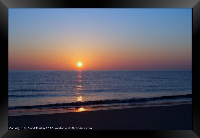 Sunrise over the sea Framed Print by David Martin