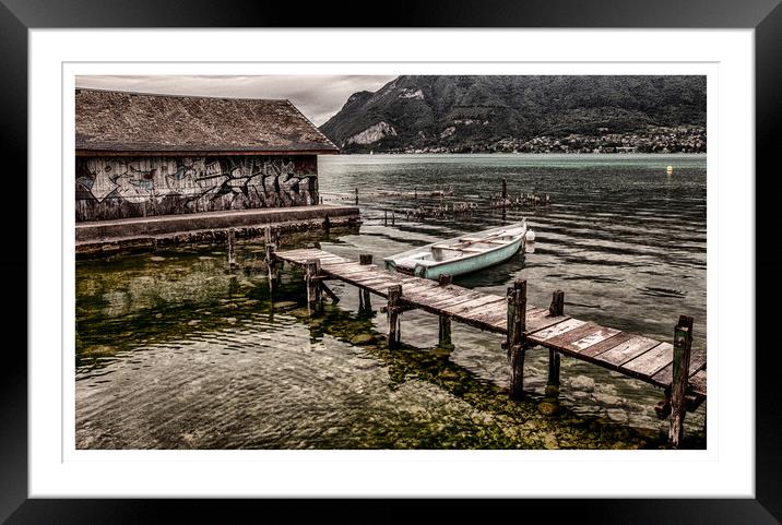 Wooden boat by boathouse with graffiti  Framed Mounted Print by Lesley Carruthers