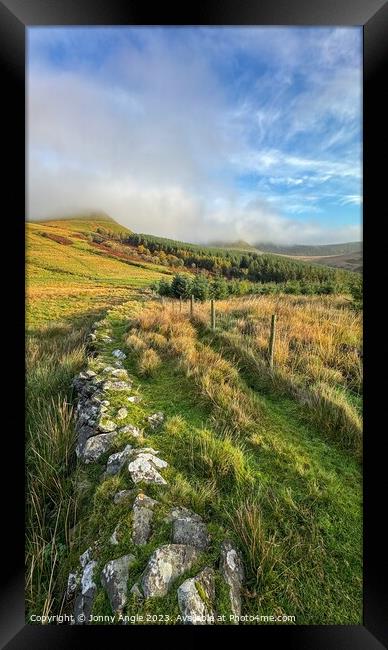 misty sunrise over stone wall and mountains  Framed Print by Jonny Angle