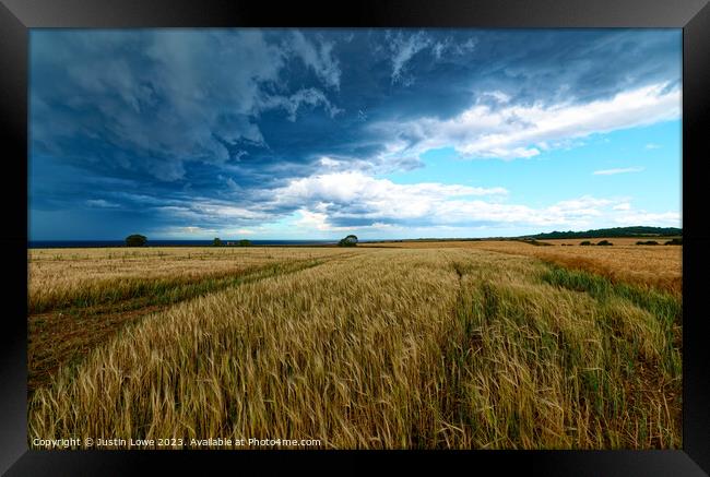 Field on Norfolk Coast as storm comes in Framed Print by Justin Lowe