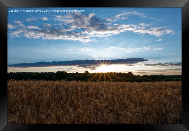 Setting sun over wheat field Framed Print by Justin Lowe