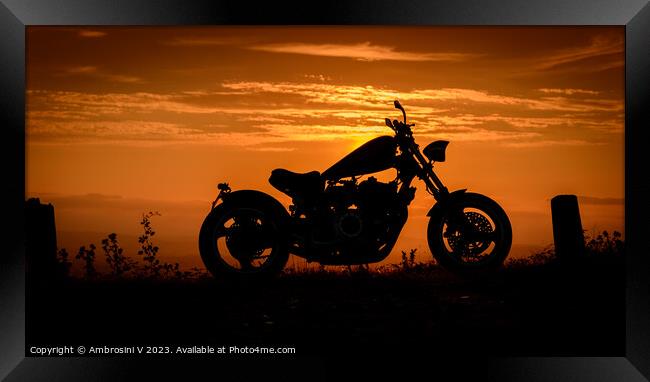 A silhouette of a custom made chopper motorbike against a colourful sunset Framed Print by Ambrosini V