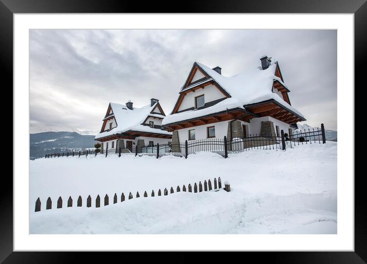 Wooden house under heavy snow, Zakopane, Poland. Framed Mounted Print by Olga Peddi