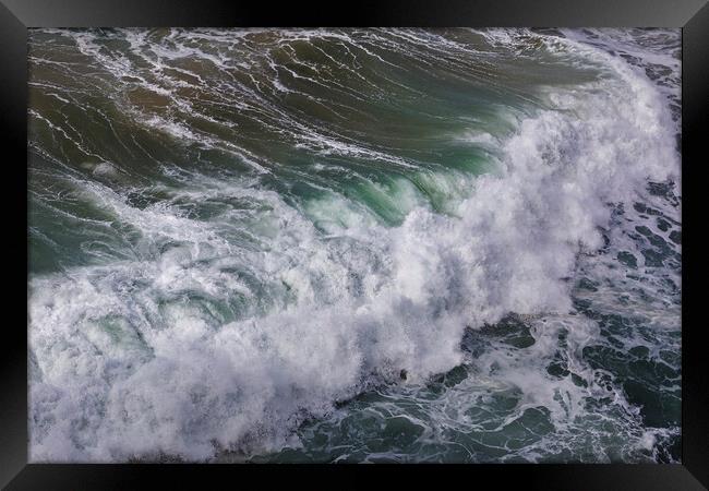Wild wave in Nazare at the Atlantic ocean coast of Framed Print by Olga Peddi