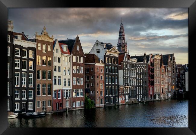 Houses along an Amsterdam canal. Summer cloudy day Framed Print by Olga Peddi