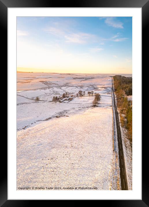 Long Snowy Road, Northumberland Framed Mounted Print by Bradley Taylor