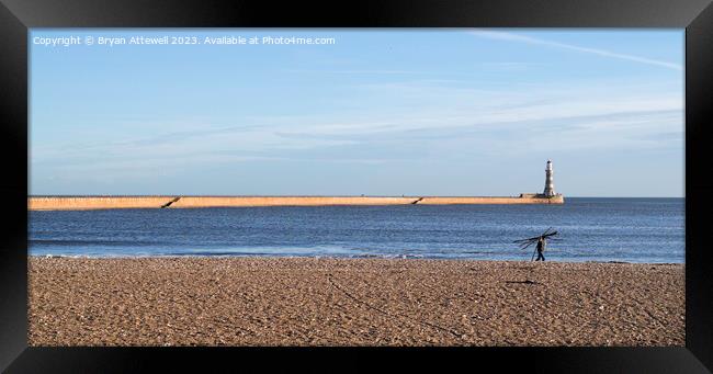 Man carrying driftwood, Roker beach, Sunderland. Framed Print by Bryan Attewell