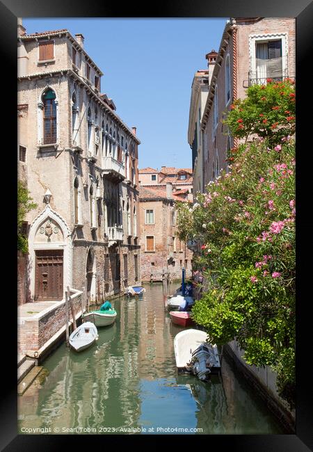 A Venice canal with boats Framed Print by Sean Tobin