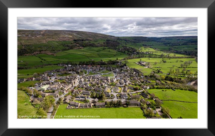 A herd of sheep grazing on a lush green field with Yorkshire Dales in the background Framed Mounted Print by Man And Life