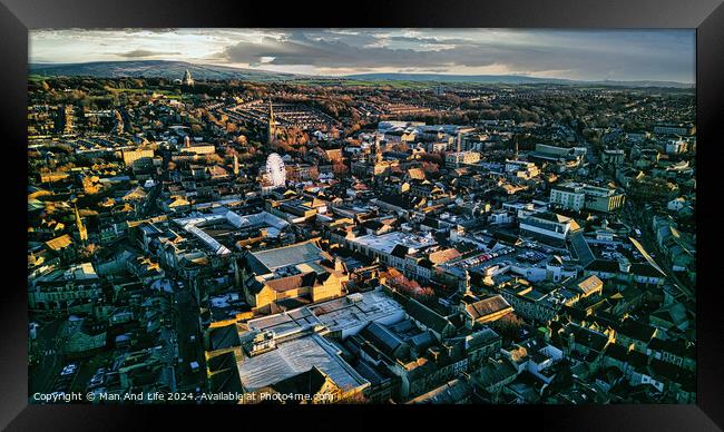 Aerial view of a city Lancaster at sunset with warm lighting highlighting the buildings and streets, showcasing the urban landscape. Framed Print by Man And Life