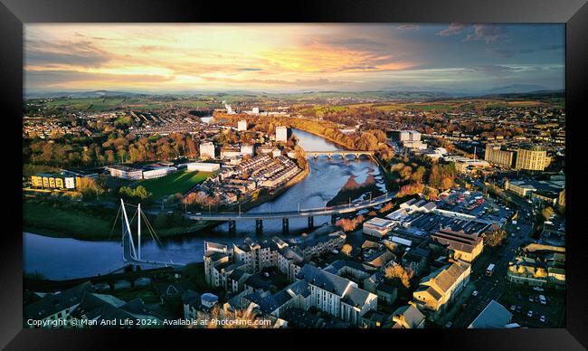 Aerial view of a city Lancaster at sunset with a river, bridges, and warm lighting. Framed Print by Man And Life
