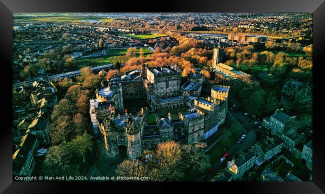 Aerial view of a majestic Lancaster castle surrounded by greenery with a town in the background during sunset. Framed Print by Man And Life