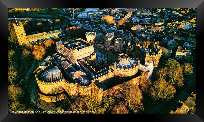 Aerial view of a majestic medieval Lancaster castle at sunset, with surrounding greenery and town in the background. Framed Print by Man And Life