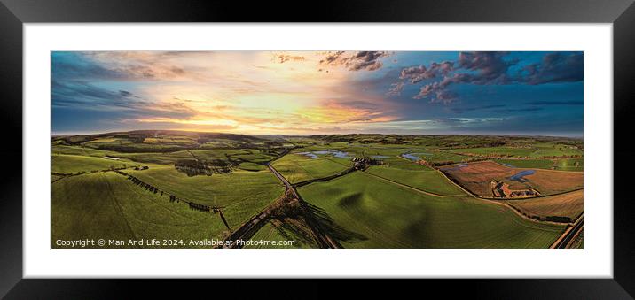 Panoramic view of a lush countryside at sunset with vibrant skies and rolling hills. Framed Mounted Print by Man And Life